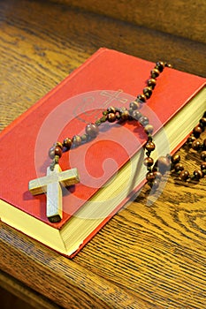 Hymnal book and wooden rosary bead