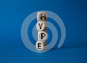 Hype symbol. Concept word Hype on wooden cubes. Beautiful blue background. Business and Hype concept. Copy space