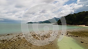 Hyper-lapse of tropical island with clouds, beach and mountain