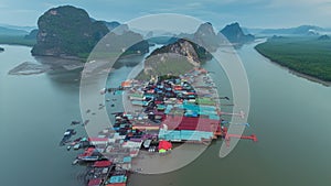 Hyperlape aerial drone view Koh Panyee island, a Famous Floating Village in Phang Nga Bay, Thailand