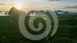 Hyperlapse aerial view drone flying over mangrove forest and mountain peak at sunrise, Phang nga bay, Thailand