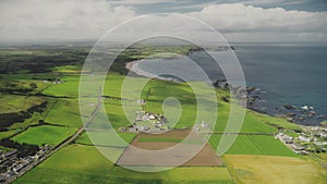 Hyperlapse farmlands fields aerial view in Antrim County, Ireland. Fast-track shot above countryside