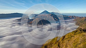 Hyperlapse flying to Bromo volcano above sea of clouds, Java, Indonesia