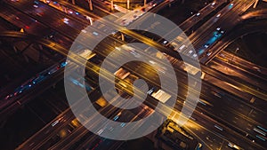 Hyperlapse Time-lapse of car traffic transport on crossing lanes highway or expressway in Asia city at night, drone aerial view