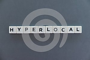 Hyperlocal word made of square letter word on grey background