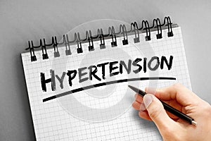 Hypertension text on notepad, concept background