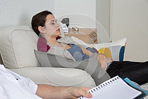 Hypnosis being practiced on a female patient