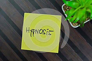 Hypnosis write on sticky notes isolated on Wooden Table