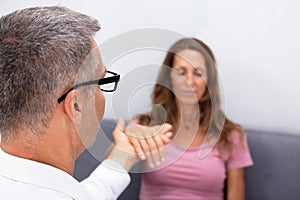 Hypnotherapist Holding Woman Hand During Hypnotherapy