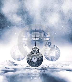 Hypnotising watch on a chain swinging above clouds. Blue tones