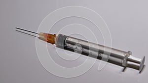 A hypodermic needle is attached to a syringe ready to be used