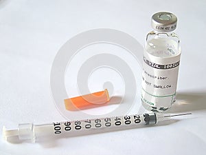 Hypodermic needle and glass vial photo