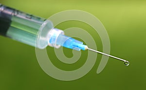 Hypodermic syringe falling herbal drop photo