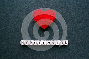 Hypotension - Low Blood Pressure. Word hypotension from white bl