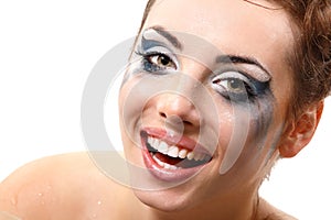 Hysterics crying and smiling woman with wet makeup over white