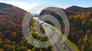 I-40 freeway in North Carolina leading to Asheville through Appalachian mountains in golden fall with fast moving trucks