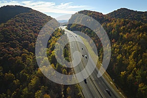 I-40 freeway road leading to Asheville in North Carolina thru Appalachian mountains with yellow fall forest and fast