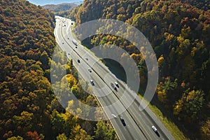 I-40 freeway road leading to Asheville in North Carolina thru Appalachian mountains with yellow fall forest and fast