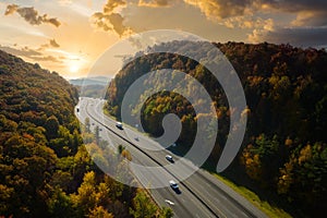 I-40 freeway road leading to Asheville in North Carolina thru Appalachian mountains with yellow fall forest and fast