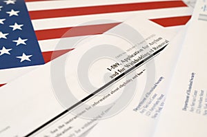 I-589 Application for asylum and for withholding of removal blank form lies on United States flag with envelope from Department of