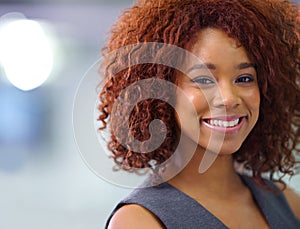 I only aim for success. Portrait of a young African American businesswoman smiling confidently at the camera.