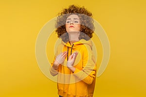 I am the best! Portrait of egoistic selfish curly-haired woman in urban style hoodie pointing herself