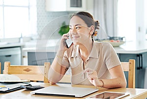 I better make that order now. an attractive young woman sitting alone and using her cellphone to work from home.