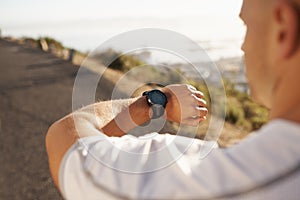 I can beat the clock. Cropped image of a male runner looking at his watch before a run.