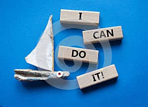 I can do it symbol. Concept words I can do it on wooden blocks. Beautiful blue background with boat. Business and I can do it