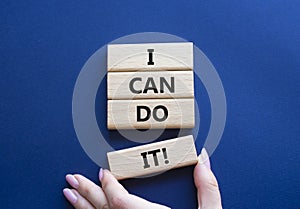 I can do it symbol. Concept words I can do it on wooden blocks. Beautiful deep blue background. Businessman hand. Business and I