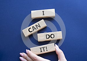 I can do it symbol. Concept words I can do it on wooden blocks. Beautiful deep blue background. Businessman hand. Business and I