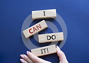 I can do it symbol. Concept words I can do it on wooden blocks. Beautiful deep blue background. Businessman hand. Business and I