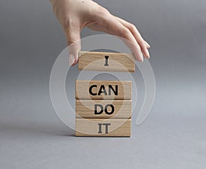 I can do it symbol. Concept words I can do it on wooden blocks. Beautiful grey background. Businessman hand. Business and I can do