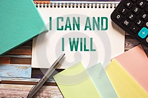 I can and I will be written on a notebook, next to colored stickers, a diary, a calculator and a pen.