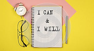 I CAN and I WILL Notice on the notepad with pen, glasses and alarm clock