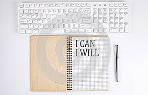 I CAN I WILL text on the notebook with keyboard on white background