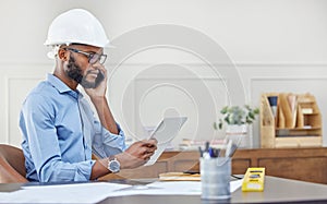 I can make some adjustments to improve your design. Shot of an architect using his tablet while talking on his cellphone