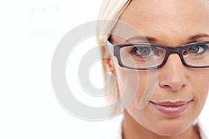 I can see clearly now. A cropped shot of a beautiful young woman wearing eyeglasses.