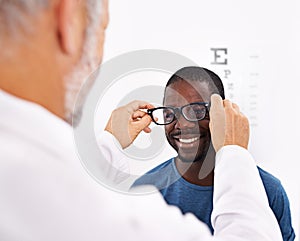 I can see clearly now...an optometrist testing a patients eyesight.