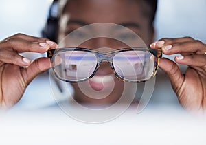 I can see everything clearly. an unrecognisable customer service agent sitting alone in the office and holding her