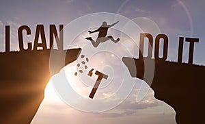 I can't do it and I can do it concept. Man jumping over cliff on sunset background. Business concept idea photo
