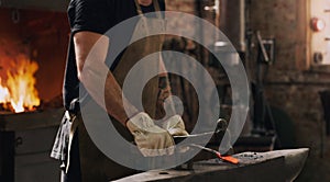 I can turn it into just about anything. a metal worker hitting a hot metal rod with a hammer in a welding workshop.