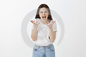 I cannot take it anymore. Portrait of stressed fed up and angry woman with dark hair, shouting and shaking palms