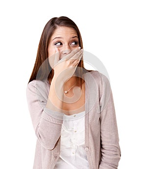 I cant believe she said that. Surprised young woman covering her mouth against a white background.