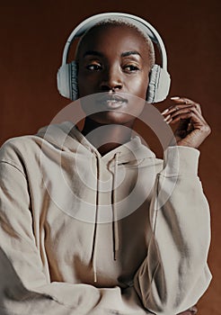 I cant hear the haters - my music is too loud. Studio shot of an attractive young woman wearing headphones and posing