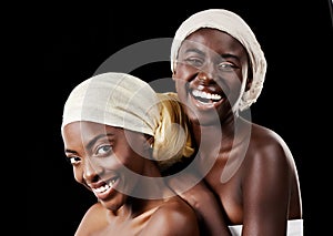 I cant imagine my life without her. Studio portrait of two beautiful women wearing headscarves against a black
