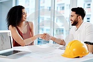 I cant wait to see how it turns out. Cropped shot of two young businesspeople sitting together and shaking hands in