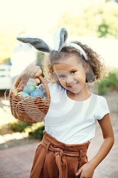 I cant wait to stuff my face. Shot of a girl carrying a basket of easter eggs.
