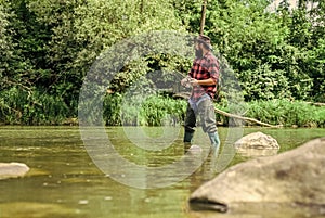 i Choose my passion. man catching fish. mature man fly fishing. fisherman show fishing technique use rod. sport activity