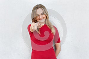 I choose you! Cropped shot of woman in red dress pointing at camera with index finger isolated over white background. Pretty woman